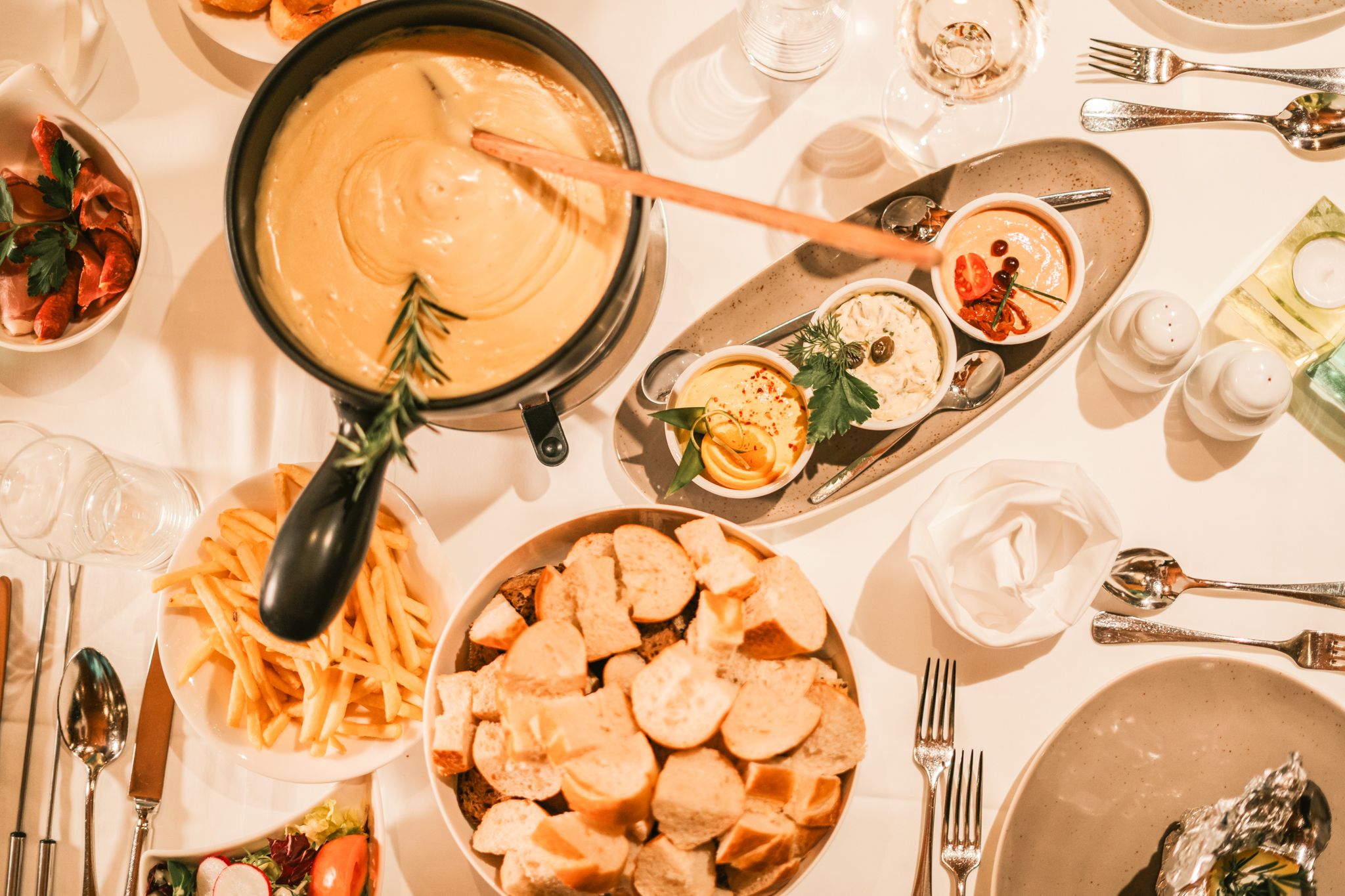 Ein gemütliches Essen mit Käsefondue und Beilagen im Glemmtalerhof in Hinterglemm.